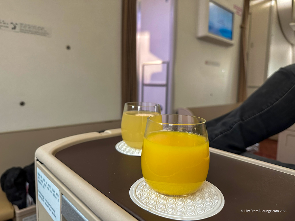 two glasses of orange juice on a table