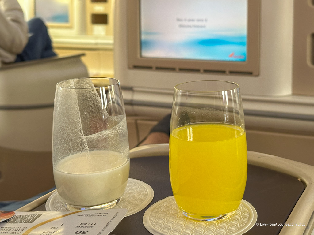 a glass of milk and a glass of orange juice on a table