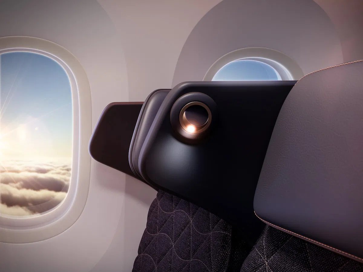 a seat in an airplane with a view of clouds and sky