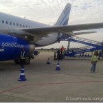 a plane with a ladder and people walking