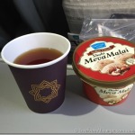 a cup of tea and a container of food