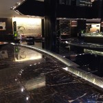 a black marble floor with a curved bar