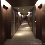 a long hallway with doors and lights