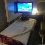 a bed with a tv above it