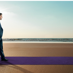 a man standing on a purple carpet on a beach