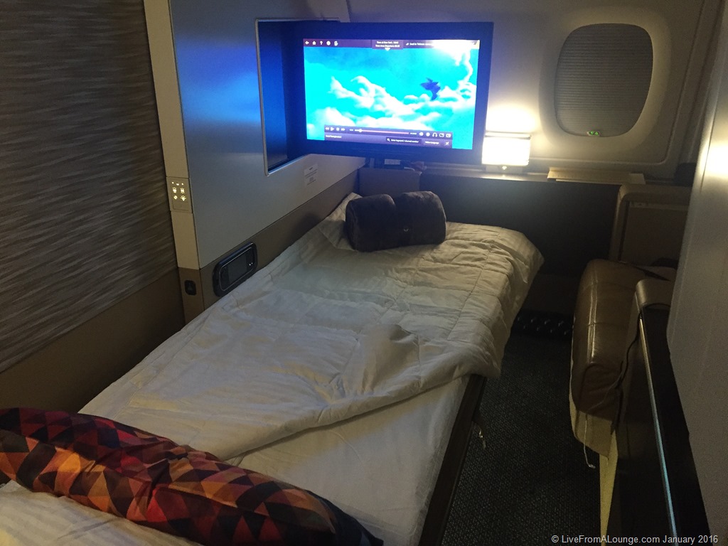 a bed with a tv above it