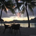 a table and chairs on a beach