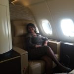 a woman sitting in a chair in an airplane