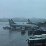 a group of airplanes parked on a wet runway