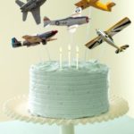 a cake with airplanes flying out of the top
