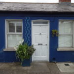 a blue house with white doors and windows