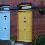 a yellow and blue doors in a brick building