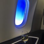 a glass of wine on a table in a plane