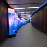 a long hallway with a large screen display