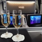 two glasses of champagne on a table in an airplane