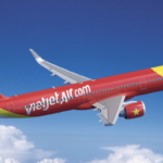 a red and yellow airplane flying in the sky