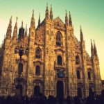 a large stone building with many spires with Milan Cathedral in the background