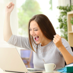 a woman with her hand up in front of a laptop