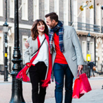 a man and woman walking on a sidewalk