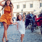 a woman and a child running on a brick road