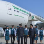 a group of people in uniform standing in front of a plane