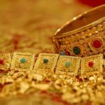 a gold bracelets and bracelets on a red surface