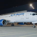 a white airplane with blue text on it