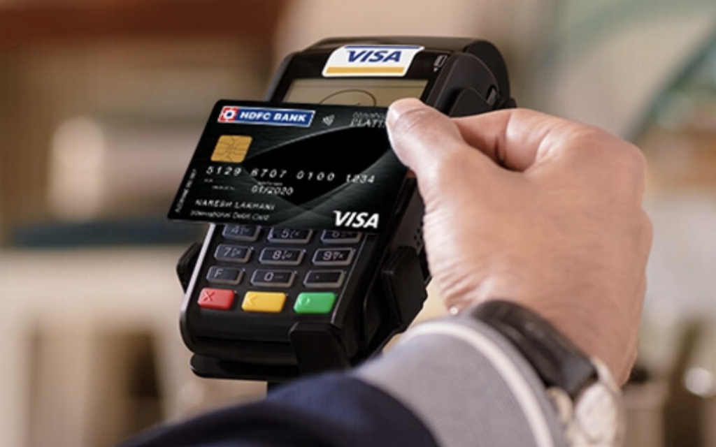 a person using a credit card reader