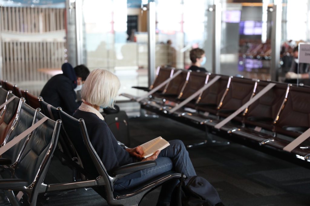 a woman sitting in chairs in an airport