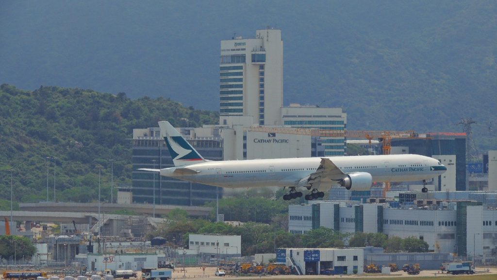 a plane flying over a runway