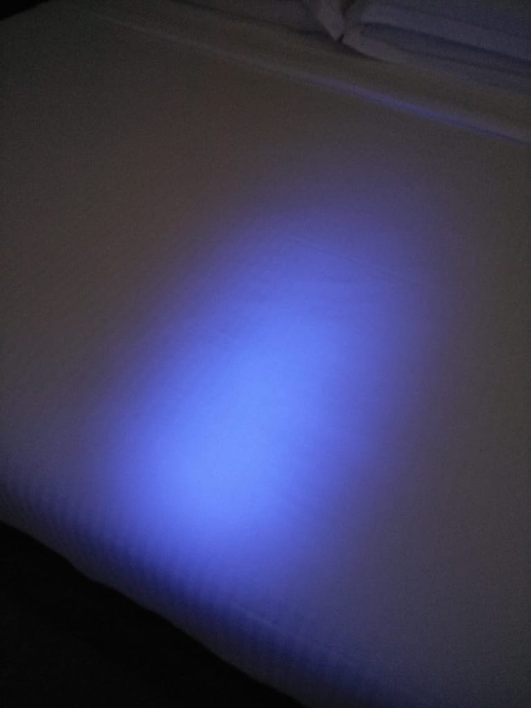 a blue light on a white surface