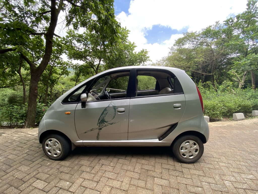 a small car parked on a brick road