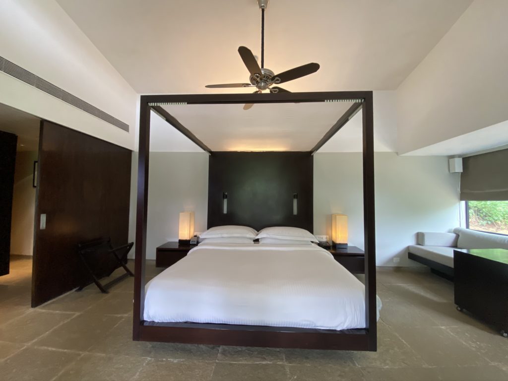 a bed with a ceiling fan