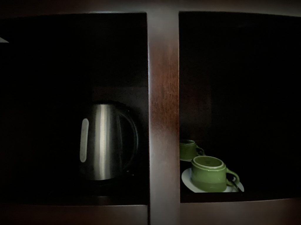 a shelf with a teapot and a cup