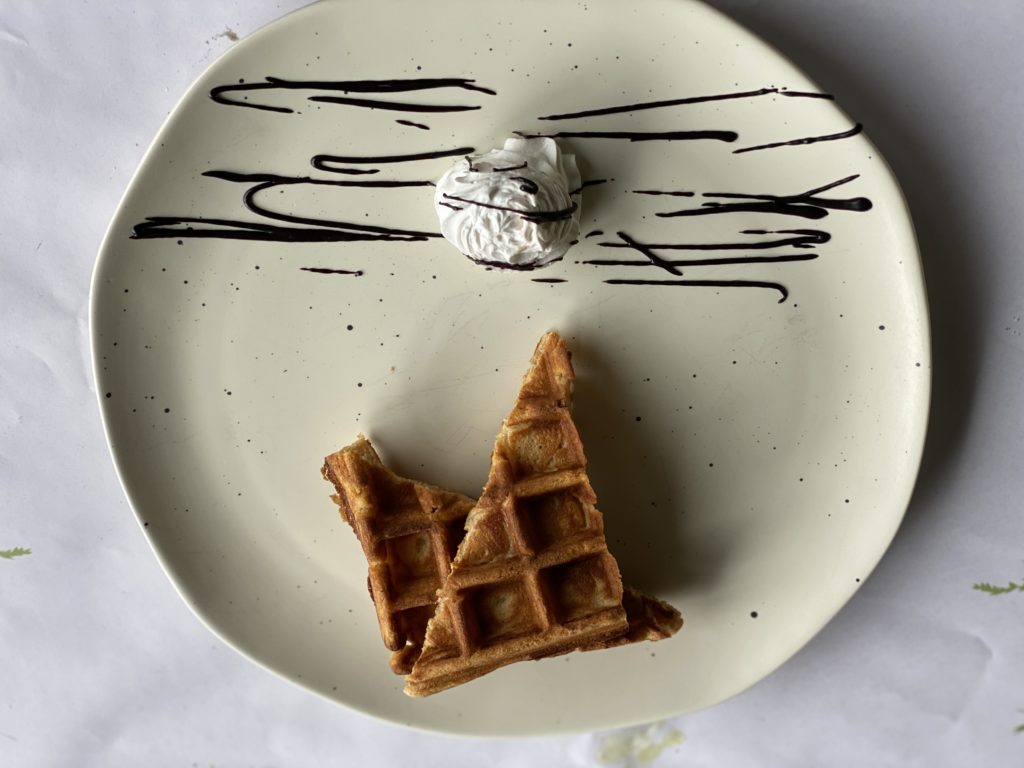 a waffle and ice cream on a plate