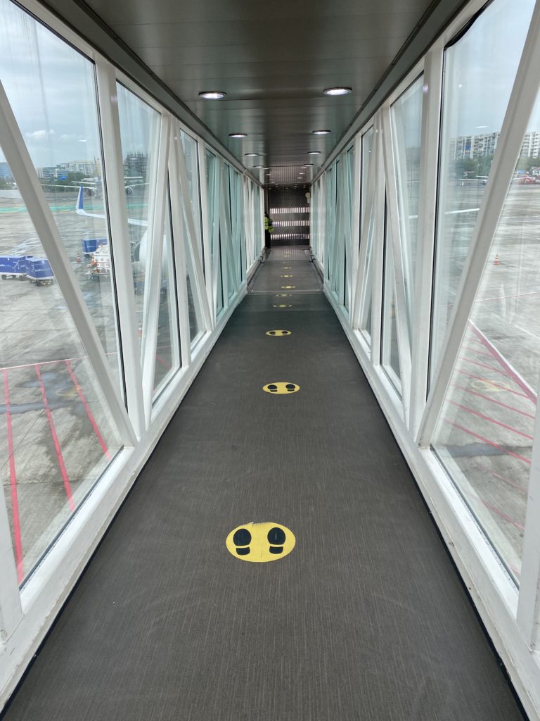 a walkway with yellow markings on it