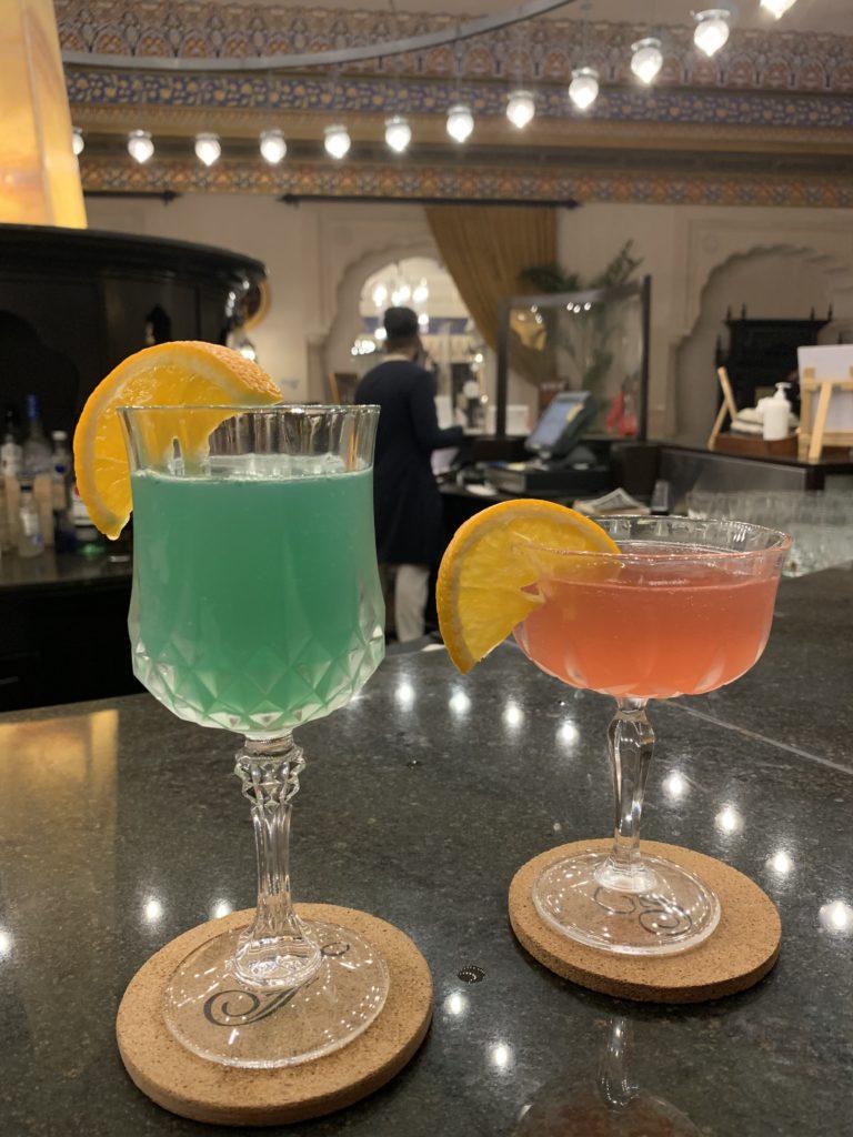 two glasses with drinks on a counter