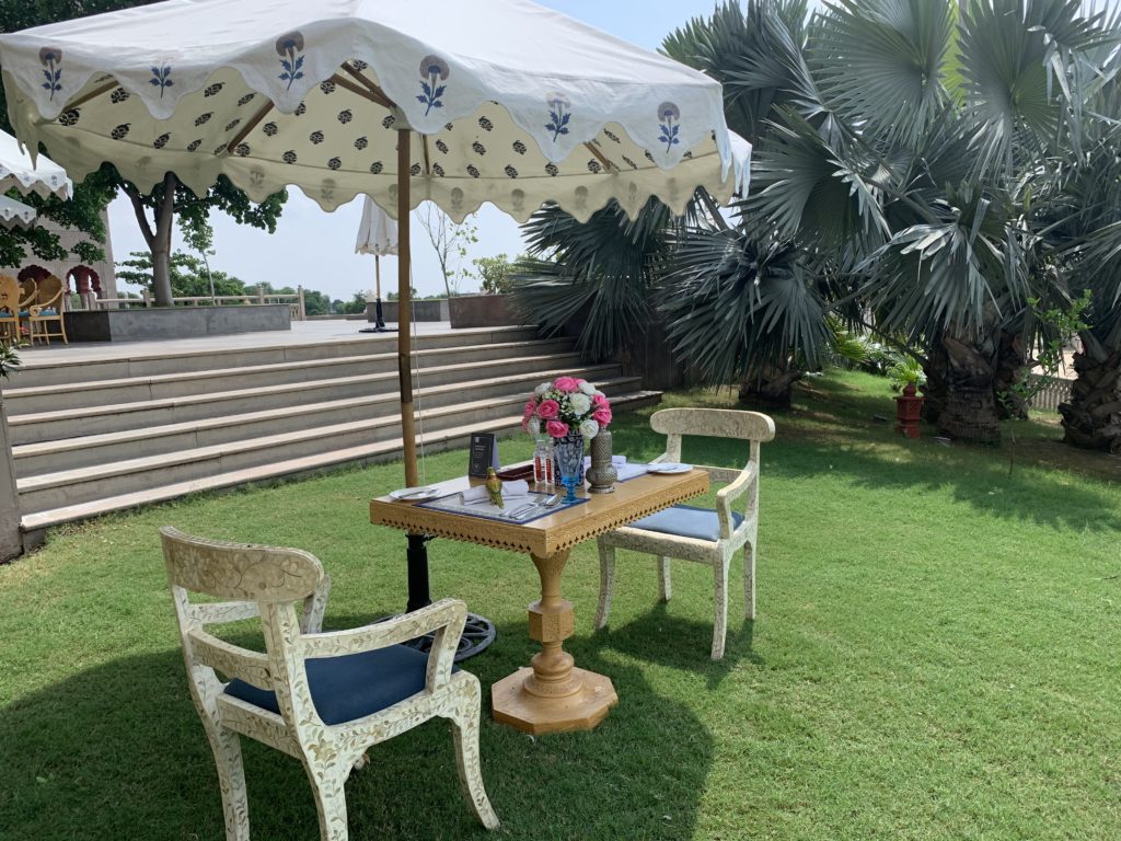 a table and chairs under an umbrella