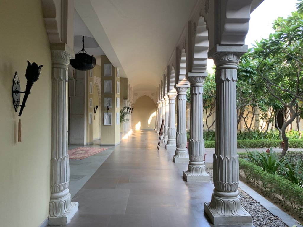 a long hallway with white pillars
