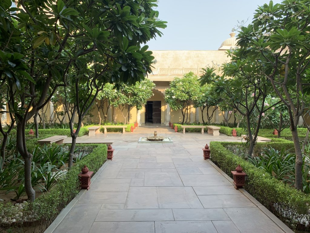 a courtyard with trees and a fountain