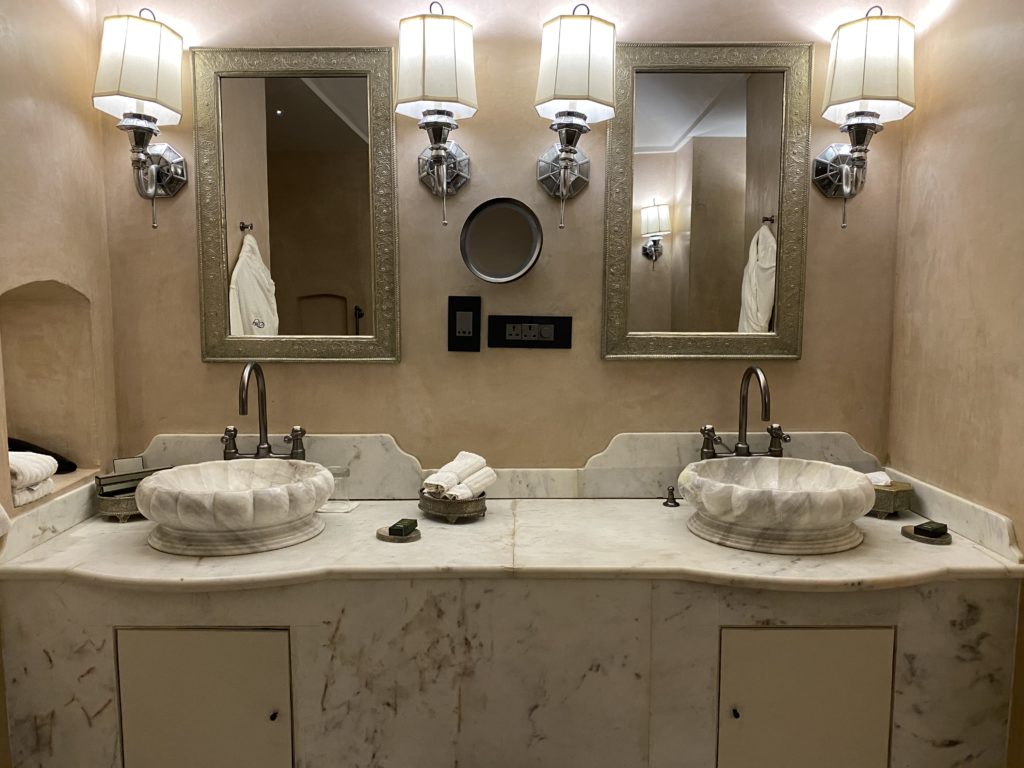 a bathroom with marble countertop sinks and mirrors