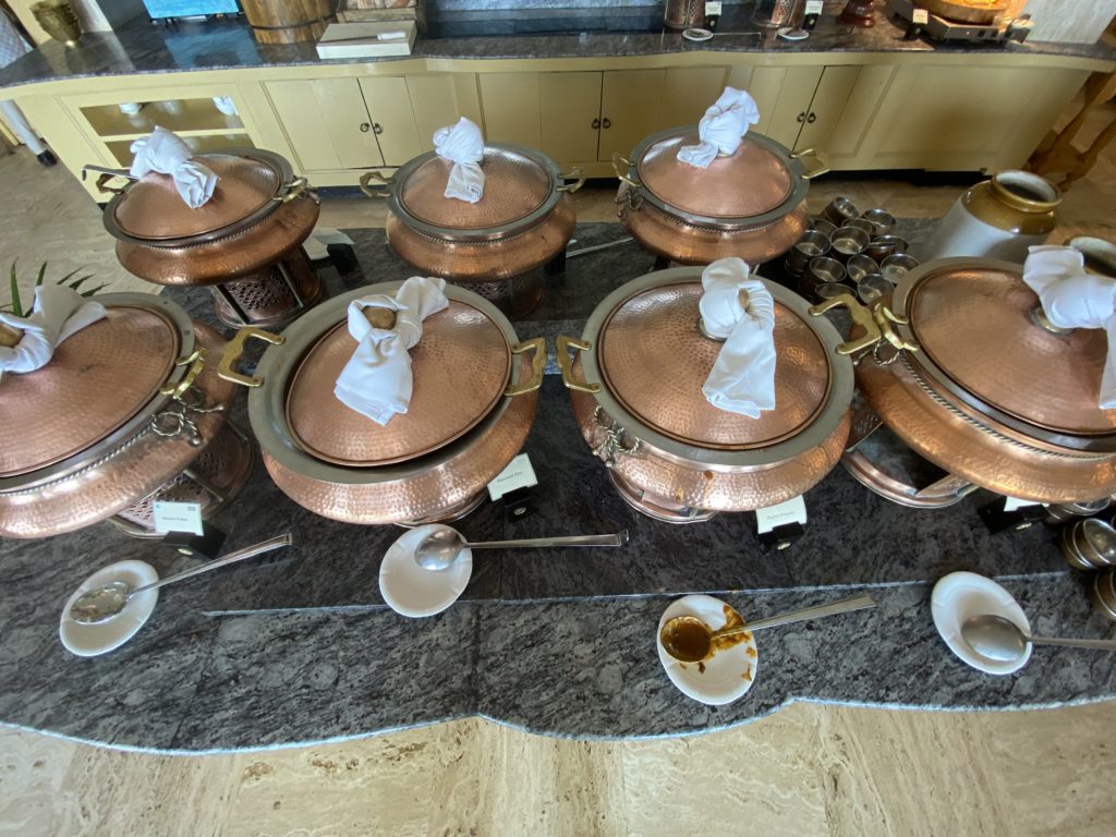 a group of copper pots with white napkins on top