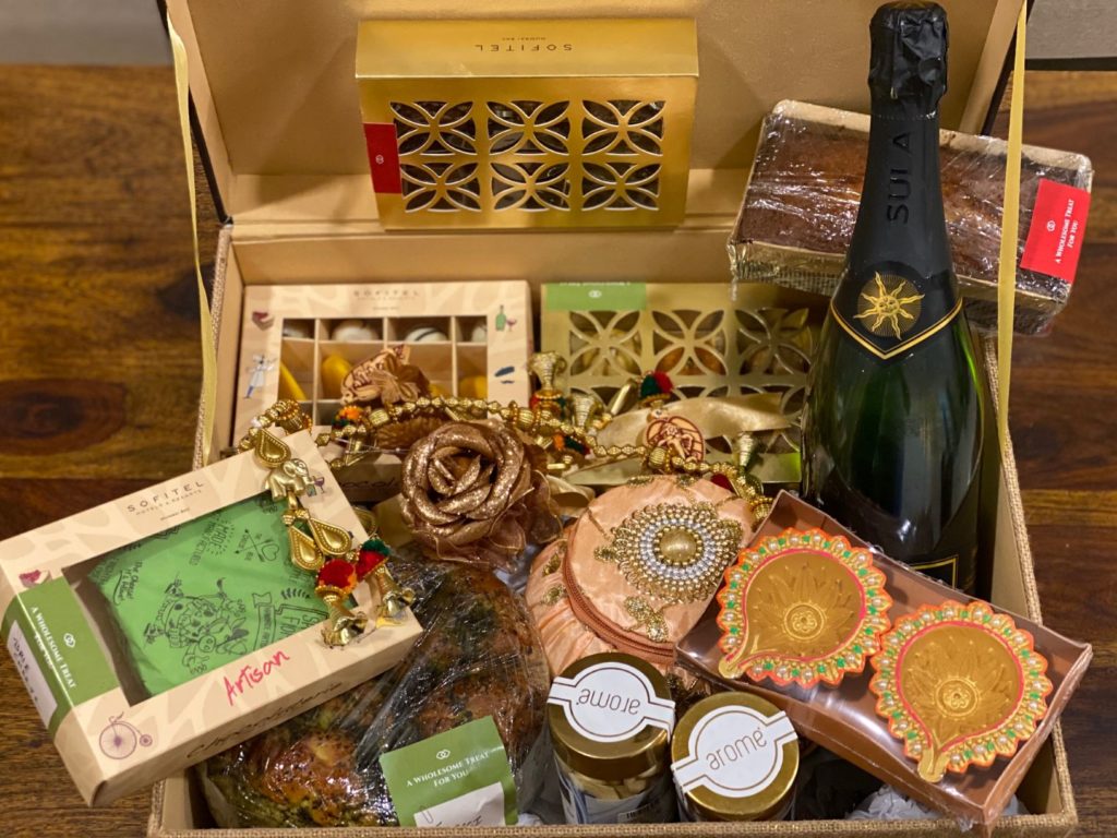 a box with food and a bottle of champagne