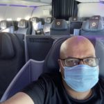 a man wearing a mask in an airplane