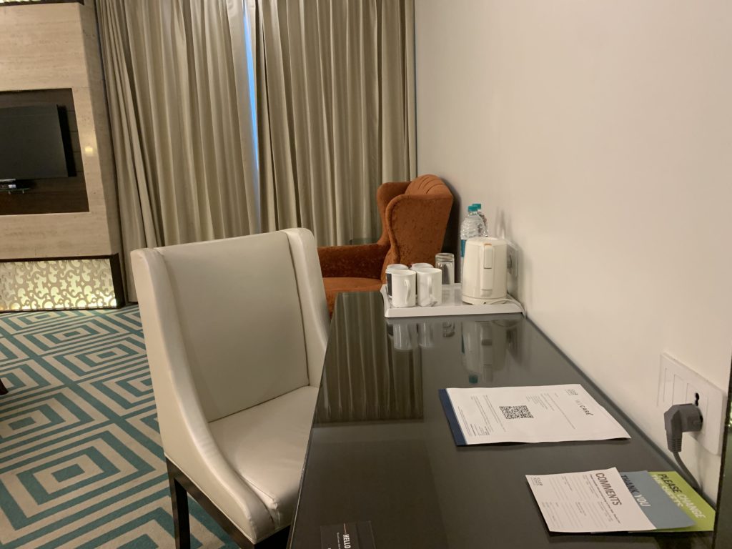 a table with papers and a chair in a room