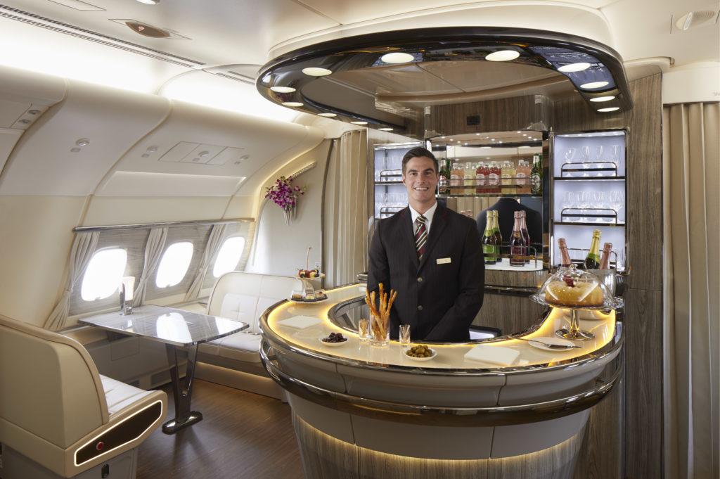 a man standing behind a bar in an airplane