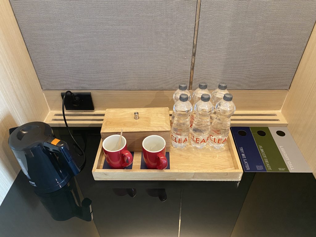 a tray with cups and bottles on it