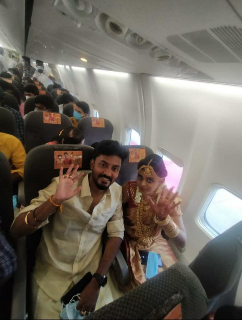 a man and woman sitting on a plane with a group of people