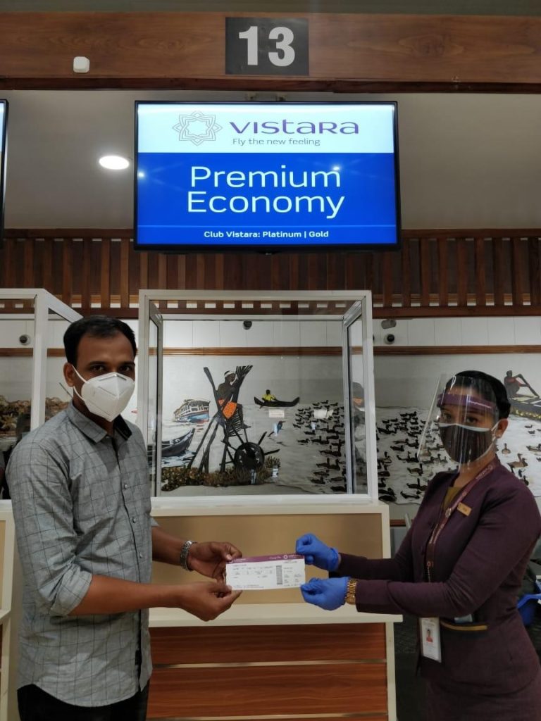 a man and woman wearing face masks and gloves holding a package