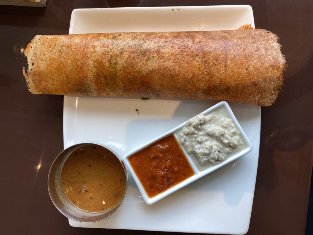 a roll of bread with sauce on a plate